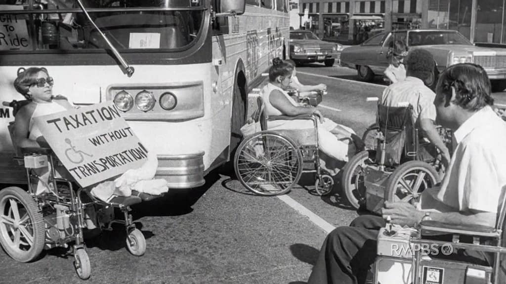 Featured Image for the Denver 19 log article. Includes woman in wheelchair with "Taxation without transportation" sign